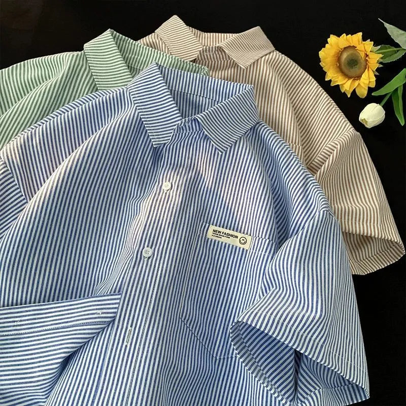 Blue and green striped loose plus size half sleeve polyester shirt on hanger