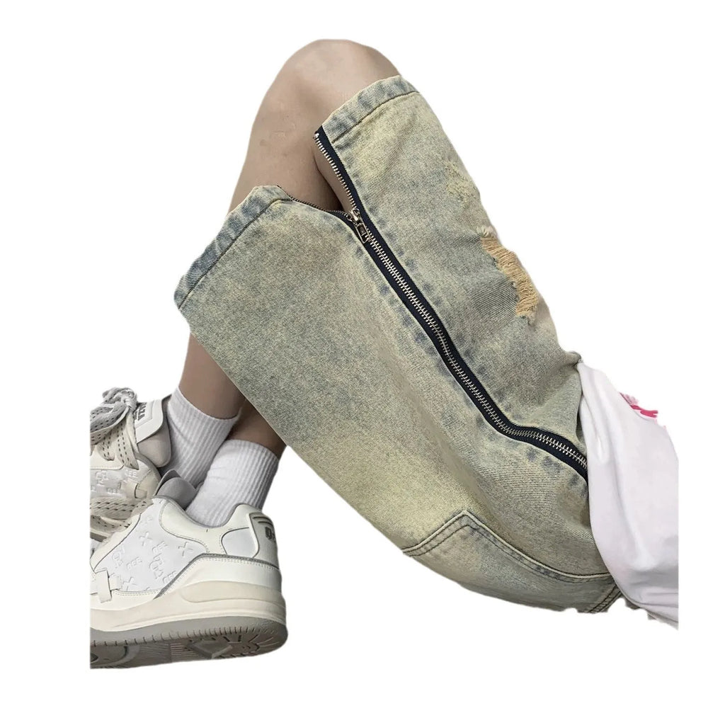 Men's blue retro denim shorts with yellow mud distressing, rips, button fly, and a loose fit.