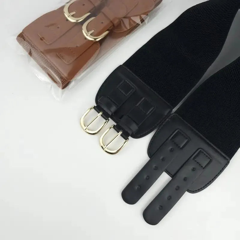 Women's black synthetic leather wide waistband with single loop on a plain background showing elastic construction