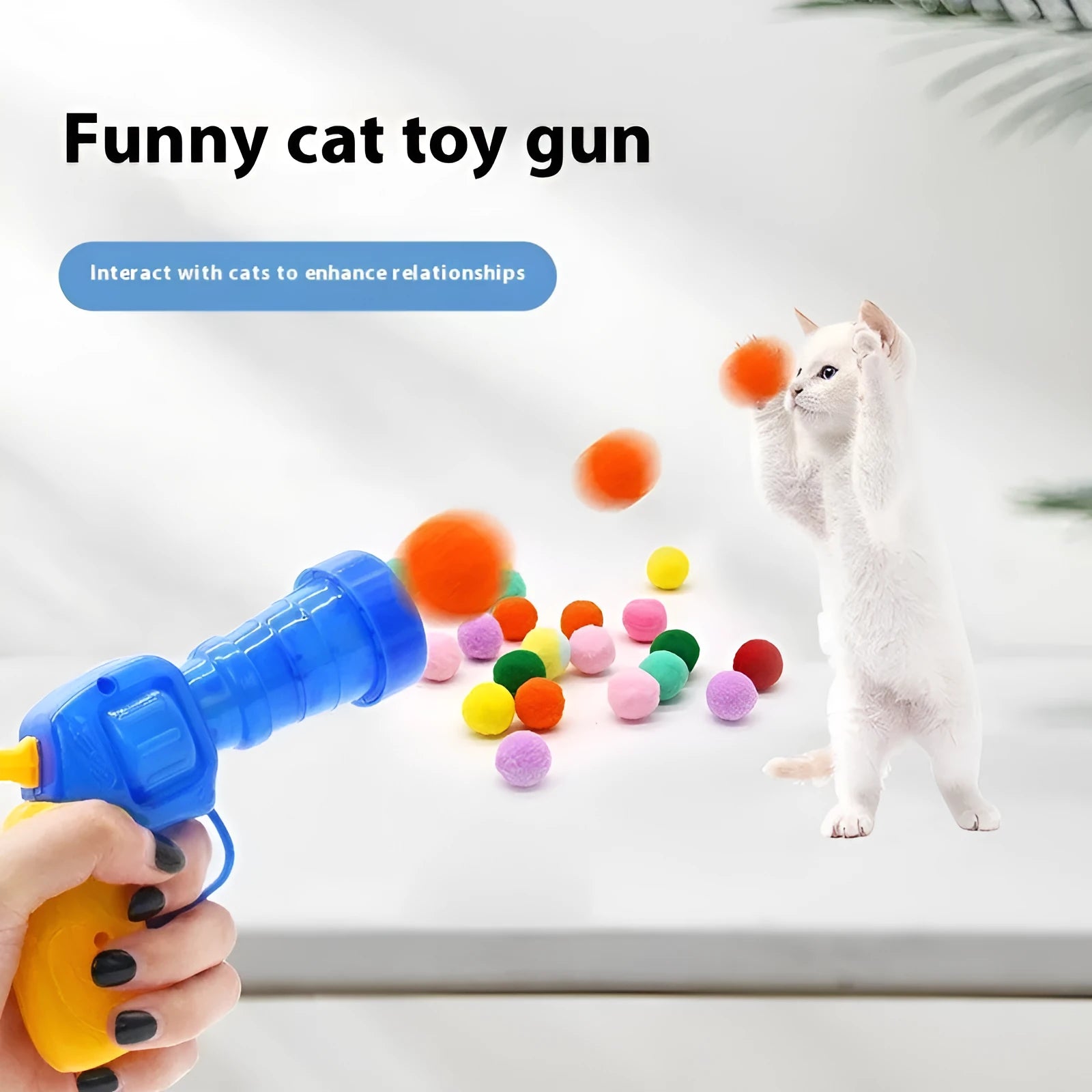 Plush cat toy launch gun with soft yarn balls for interactive indoor pet play.