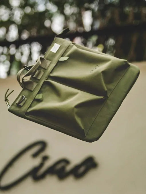 Retro style canvas crossbody messenger bag in military green with adjustable shoulder strap and zipper closure