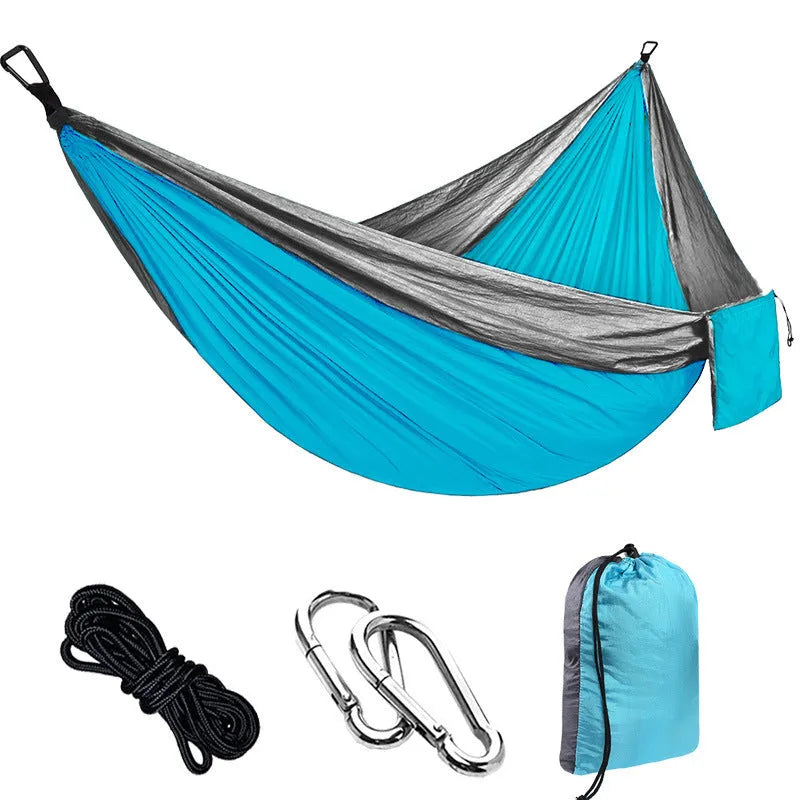 Double camping hammock with ropes and buckles shown in outdoor setting