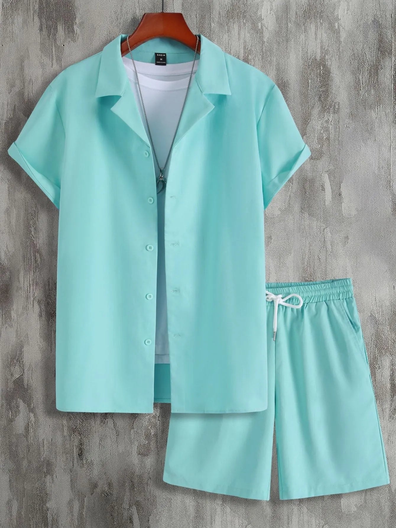 Men's white short sleeve Cuban collar sport shirt and matching shorts laid flat.