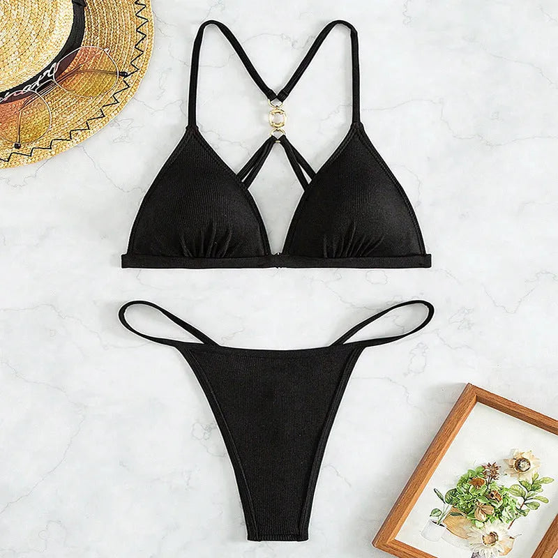 Black women's hollow backless triangle bikini top with matching T pants on a mannequin.