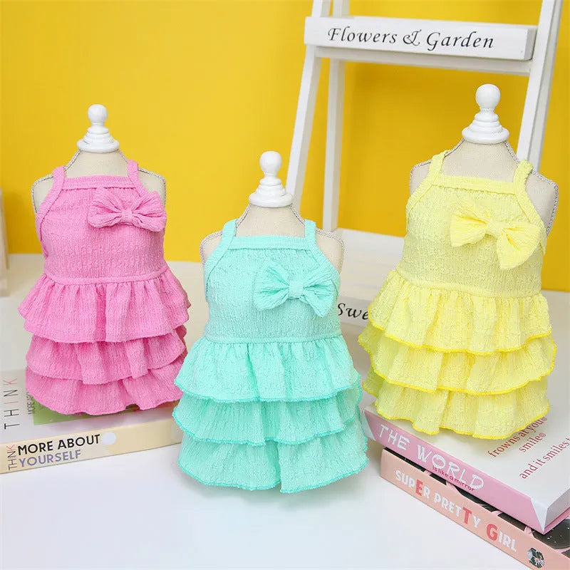 Small dog wearing candy layered skirt princess dress in rose red colour