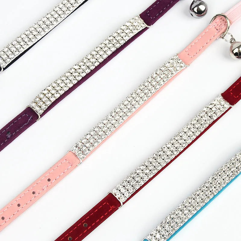 Adjustable red velvet cat collar with rhinestone details on a suede strip.