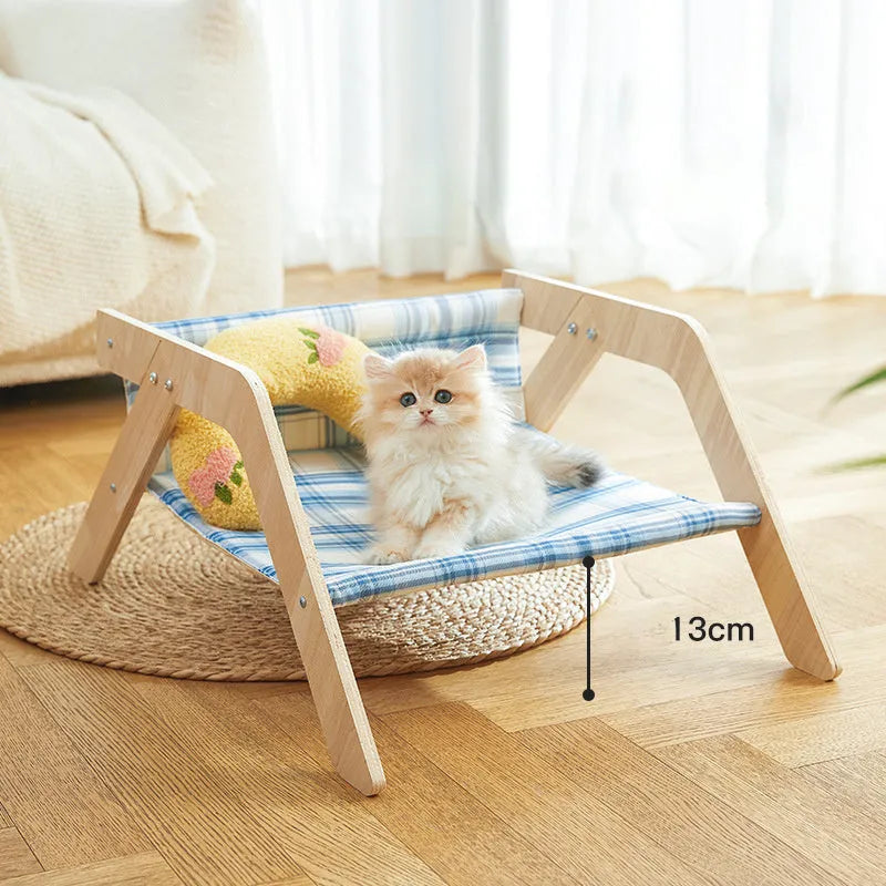 Blue wooden elevated cat bed with fabric hammock for indoor feline lounging