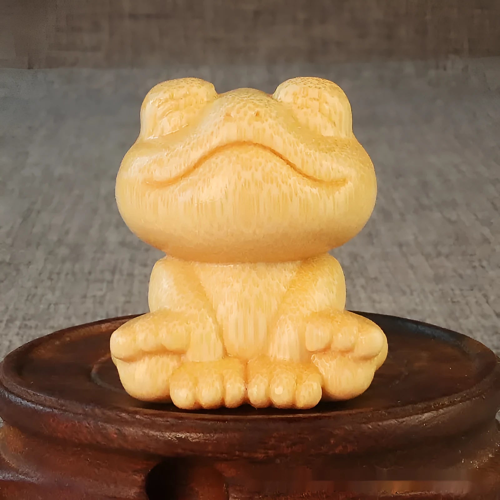 Solid bamboo carving ornament of smiling frog design measuring 5cm height and 4.5cm diameter