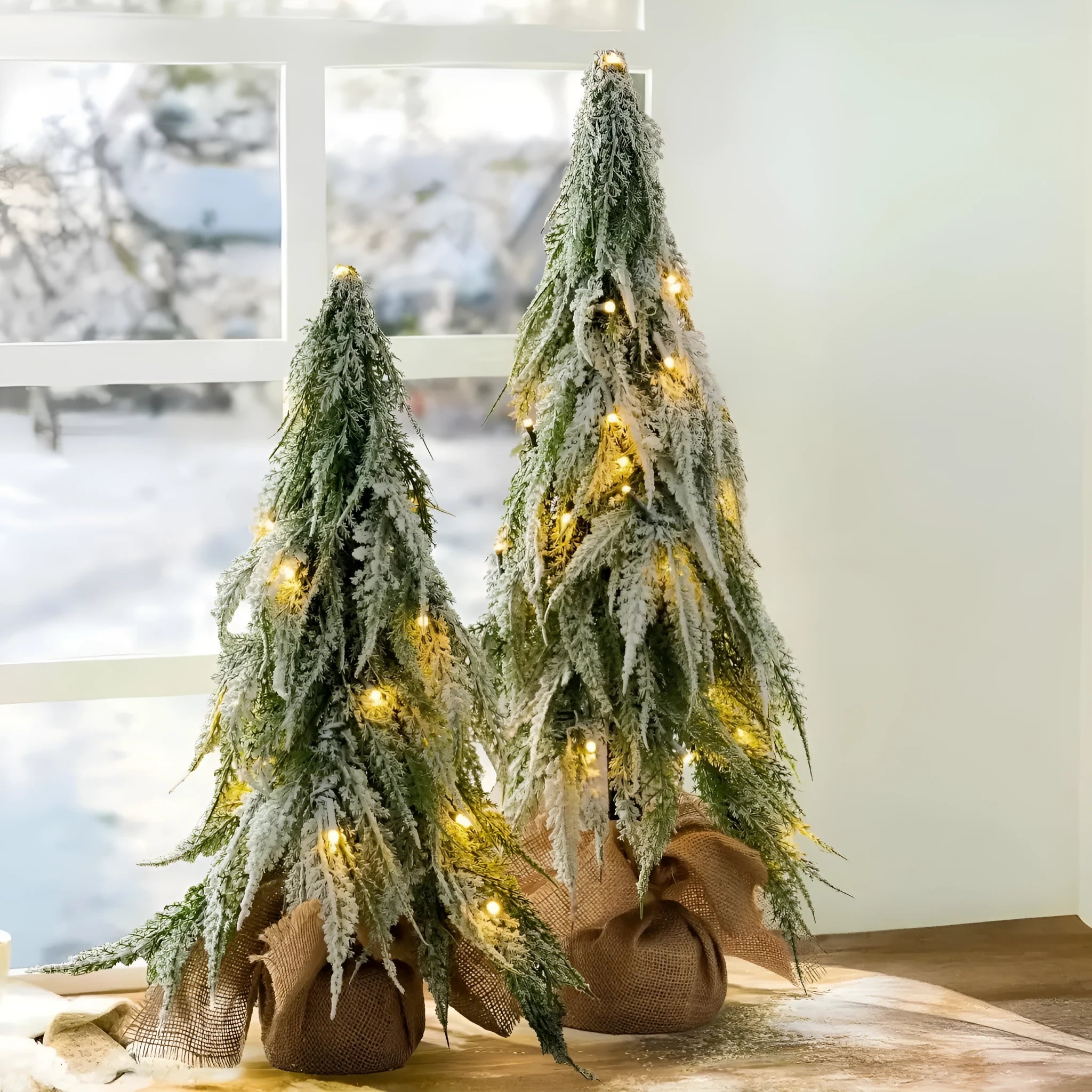 24-inch small artificial Christmas tree with snow spray decoration and built-in lights on desktop