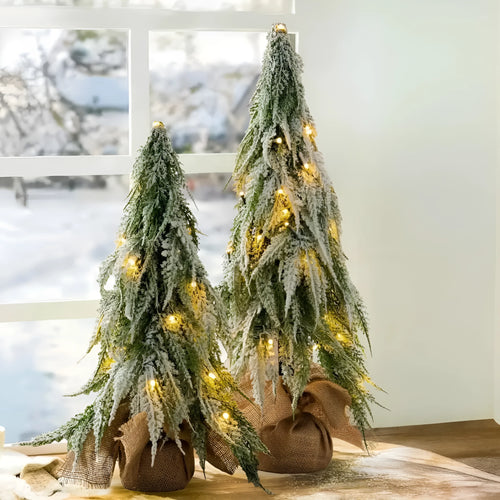 24-inch small artificial Christmas tree with snow spray decoration and built-in lights on desktop