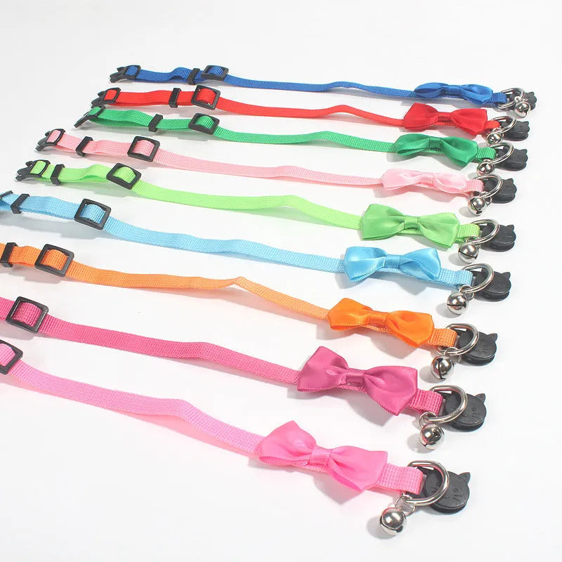 Adjustable striped nylon cat collar with a bell shown in multiple colours including red, blue, green, and pink.