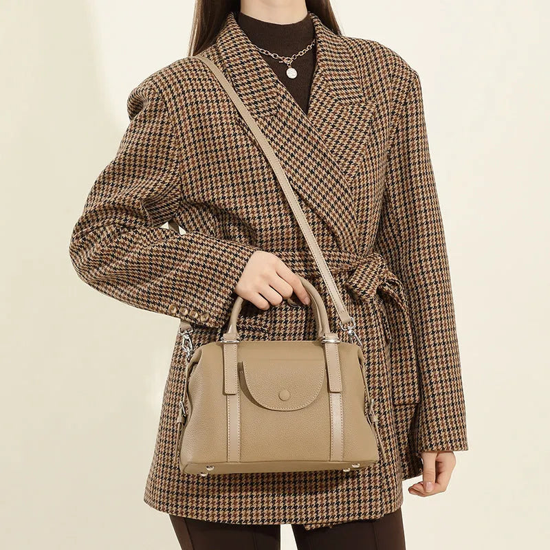 Genuine leather ladies handbag with contrast stitching and metal lock detail