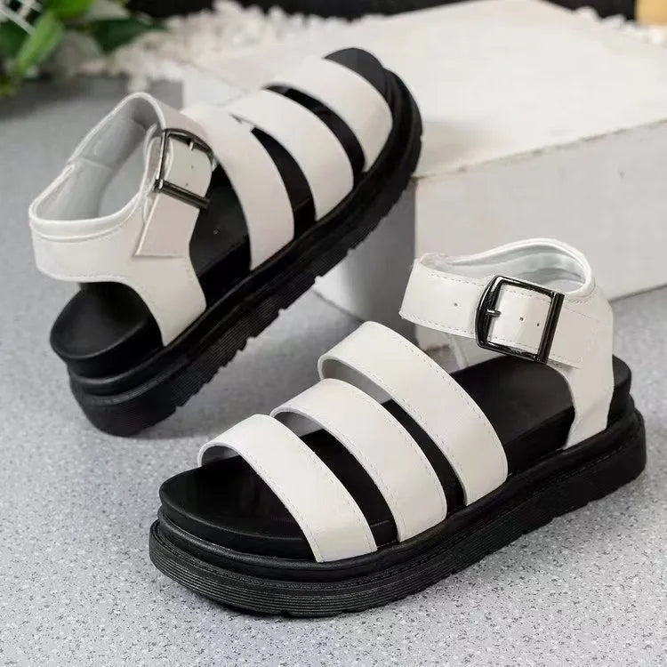 Pair of thick-soled black sandals with an adjustable buckle strap over the instep.