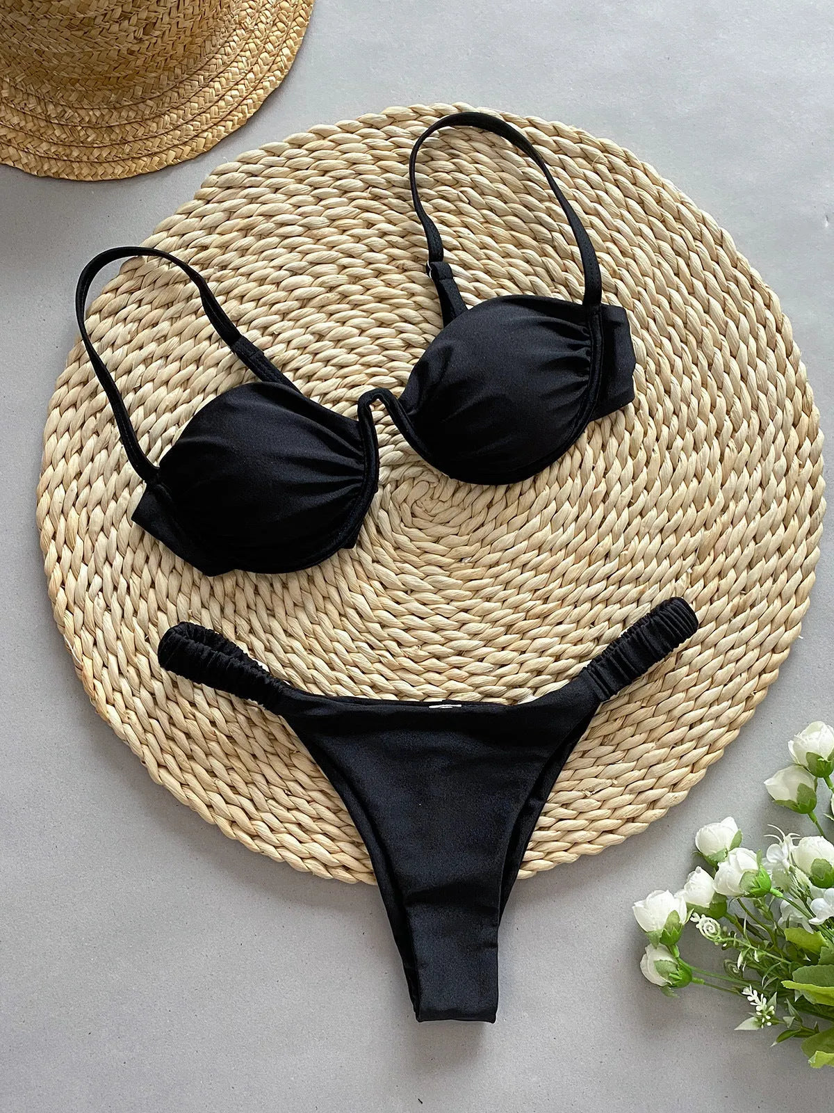 Women's black underwire bikini swimsuit set with brief bottom on a mannequin.