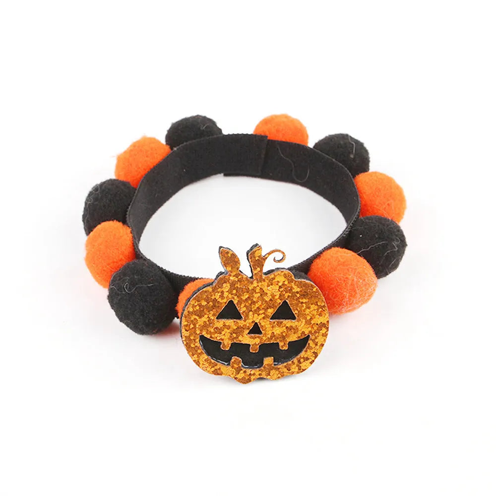 Halloween pet collar with soft fur ball pumpkin accessory in orange, sized on a dog's neck.