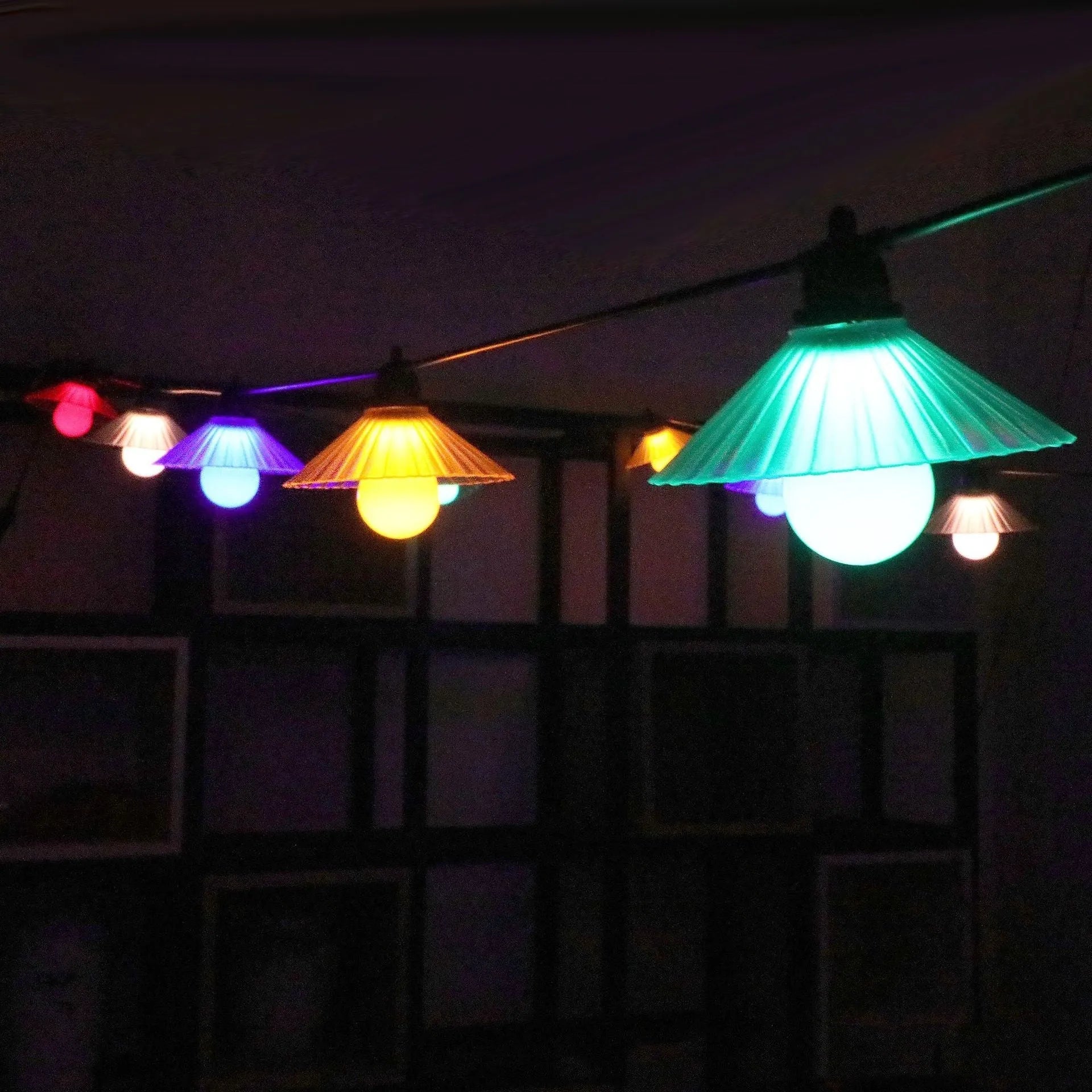 Outdoor LED string lights with flower-shaped bulbs in warm white and multicolour settings.