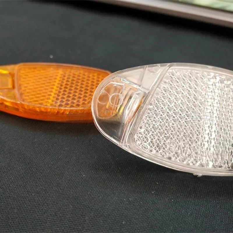 Yellow and white bicycle wheel reflector decorations for spokes measuring 7.2cm by 3.5cm