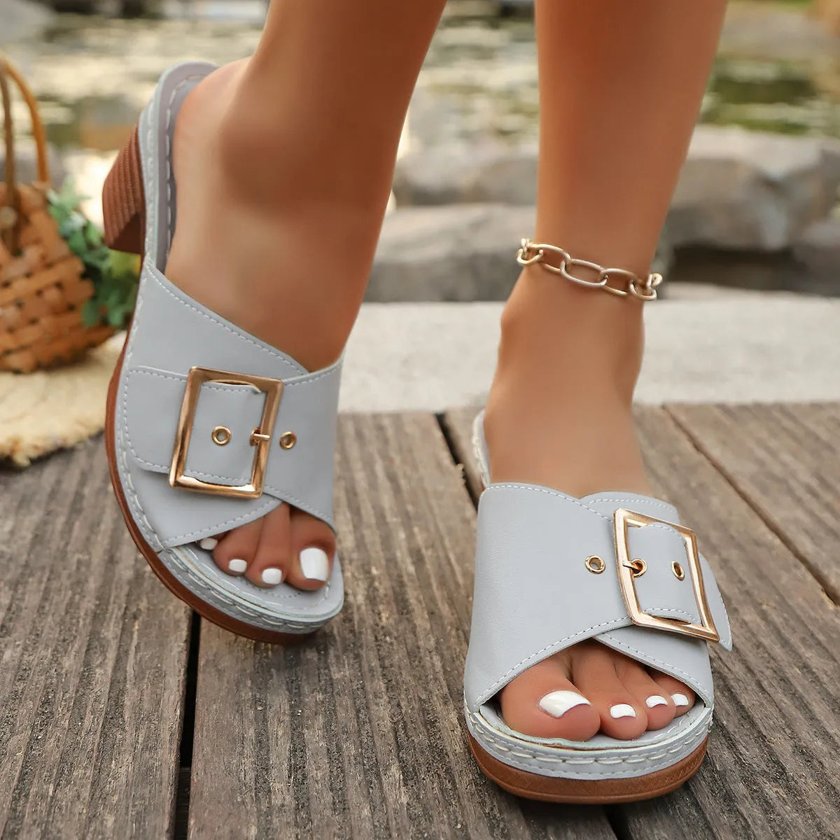 Women's retro chunky heel slippers with metal buckle detail in black or light blue, round head PU upper and rubber sole.