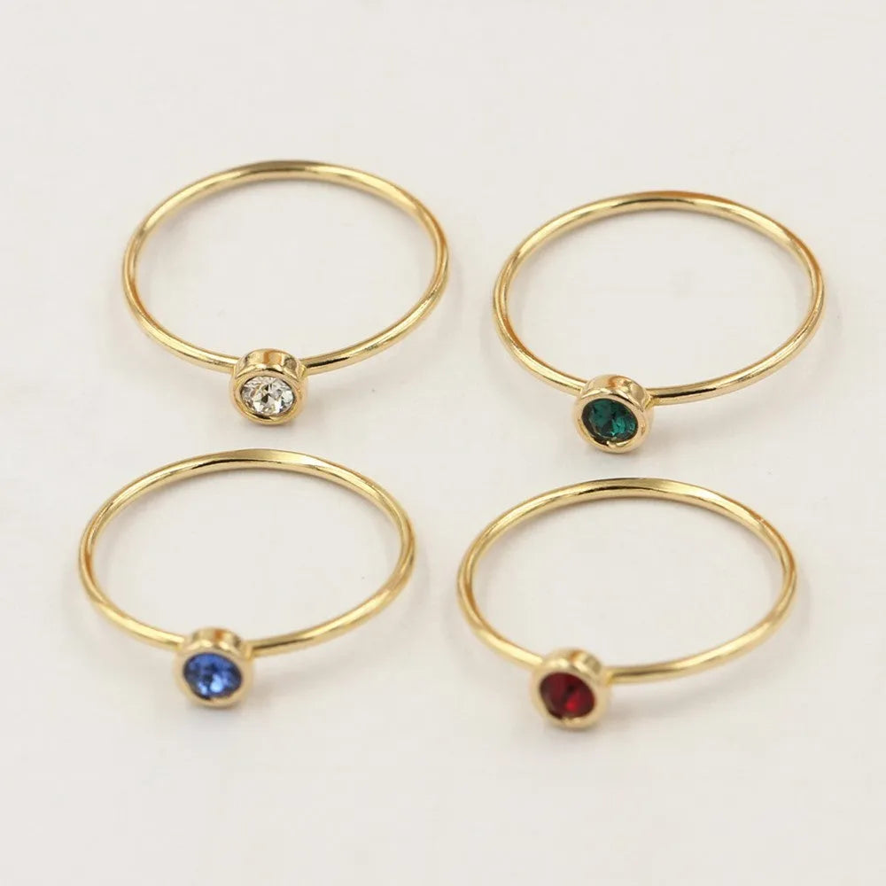 14K gold plated zircon knuckle ring on finger showing copper base with decorative stones
