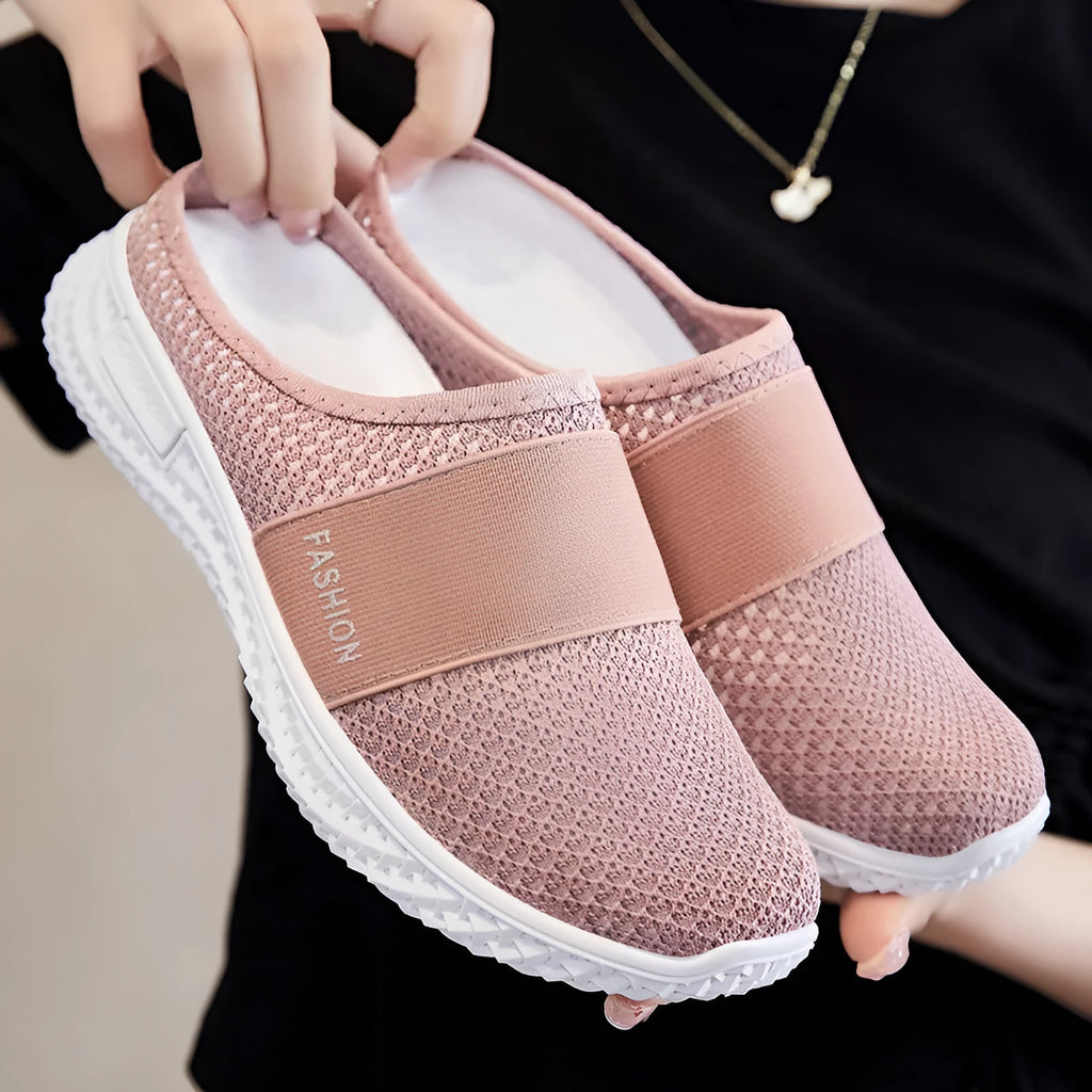 Women's casual breathable mesh shoes with hollow-out design and flat heel in black, gray, pink, or purple.