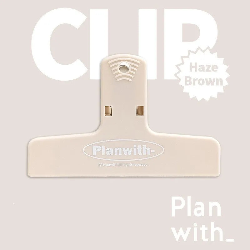 Blue and brown magnetic plastic bill clip holding paper tickets and receipts.