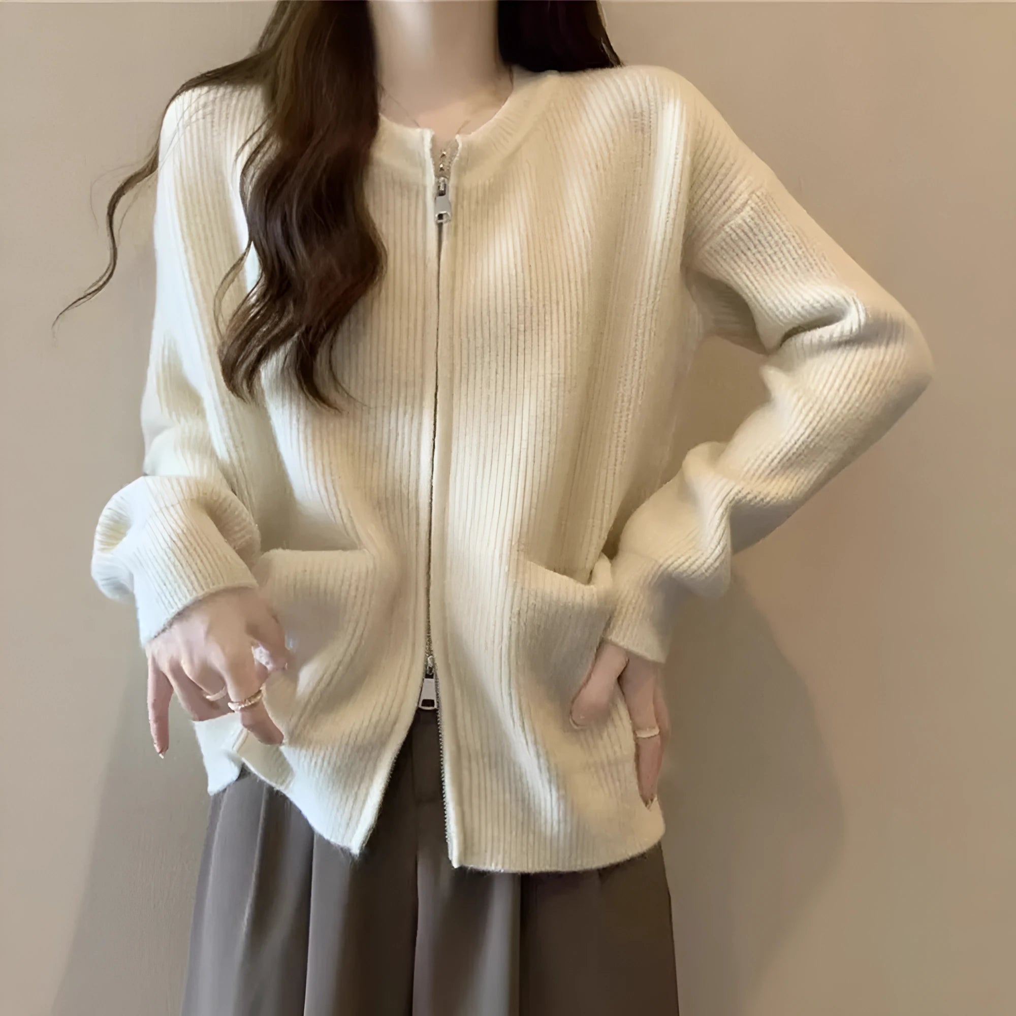 Beige viscose knit long sleeve cardigan sweater coat on a hanger