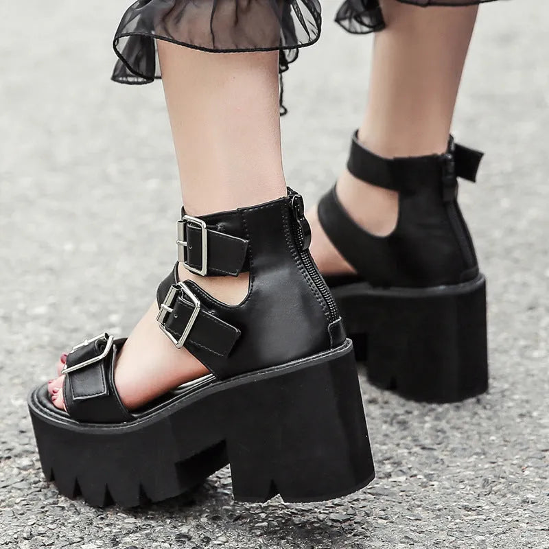 Black women's Roman style platform sandals with a chunky heel, round toe, back zipper, and decorative buckle.