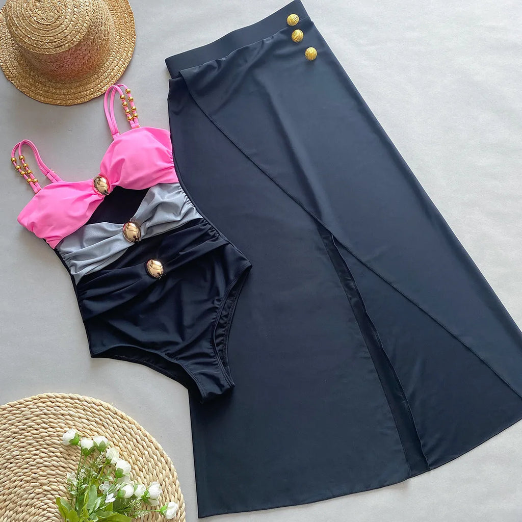 Women's brown one-piece swimsuit with matching beige skirt laid flat