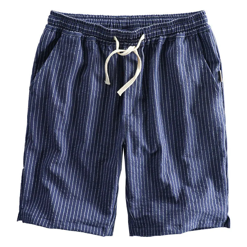 Man wearing black and white striped cotton casual shorts with a loose straight leg and elasticated waist.