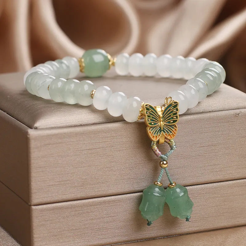 Green crystal women's bracelet with Tian Shan Cui abacus beads and retro butterfly tassel design