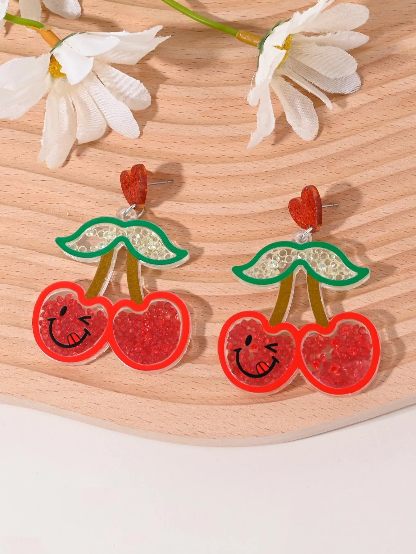 Colourful acrylic fruit and ice cream dangle earrings for women on a white background.