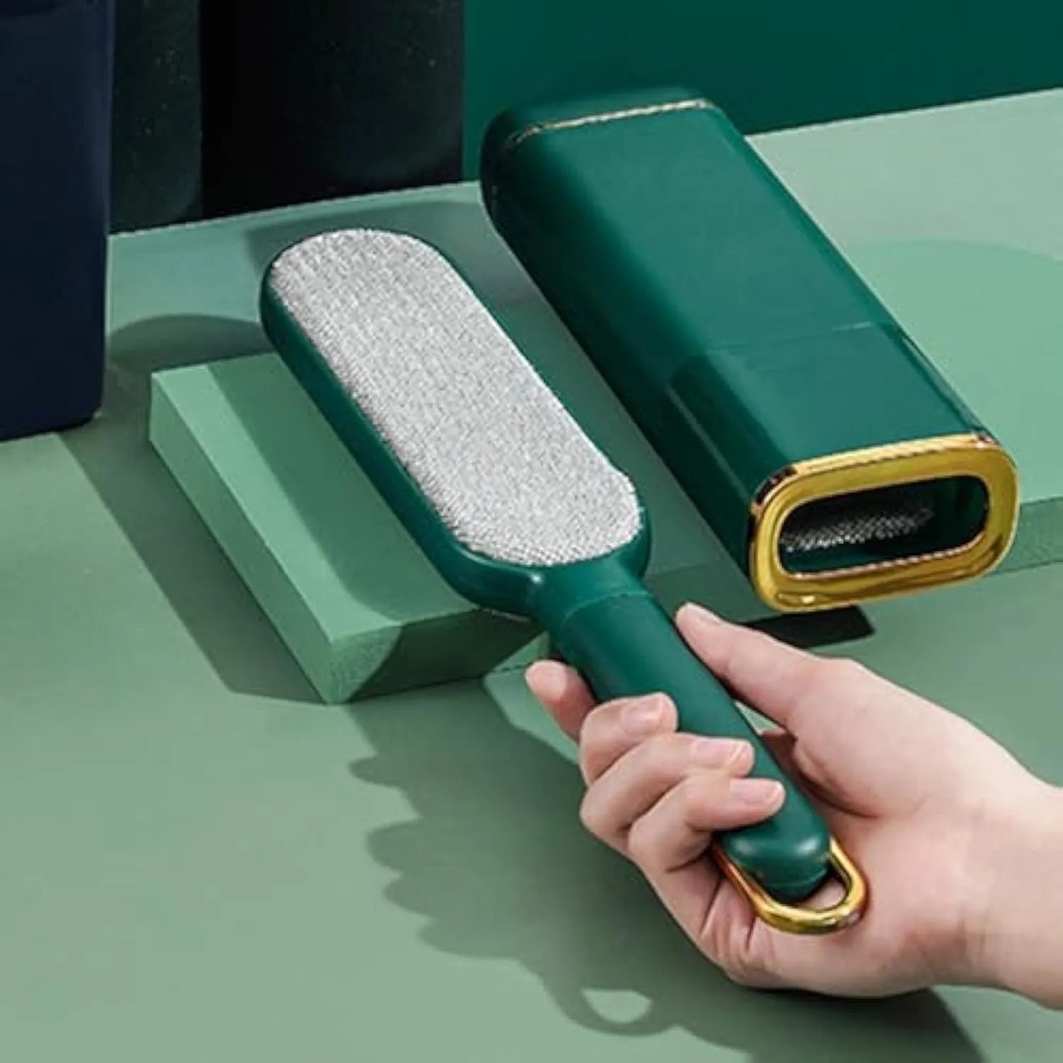 Blue reusable pet hair remover brush with a self-cleaning storage base on a fabric sofa.