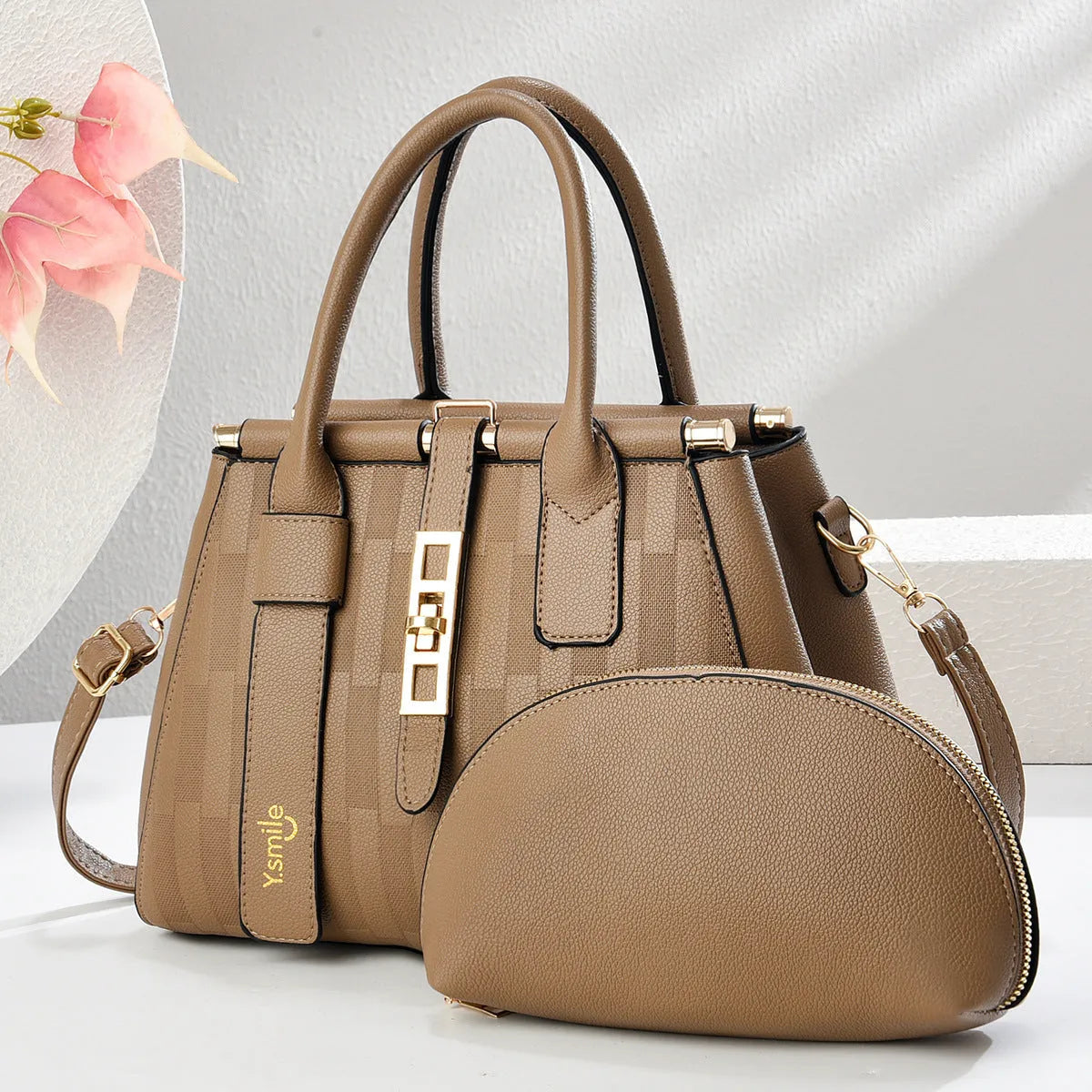 Round PU leather crossbody handbag in light khaki colour showing front view and adjustable shoulder strap.