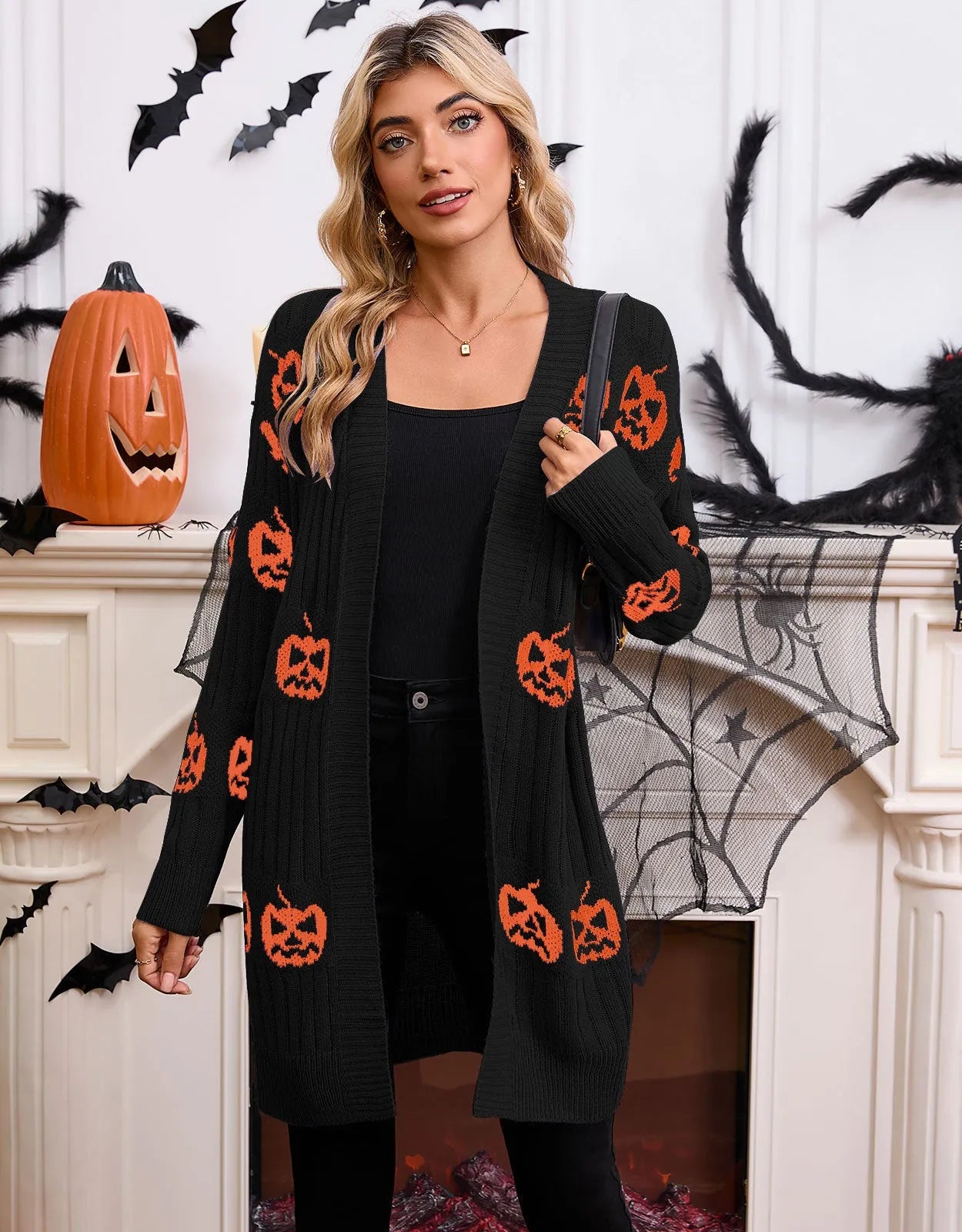 Women's black Halloween cardigan with orange Jacquard pumpkin head pattern on the front.