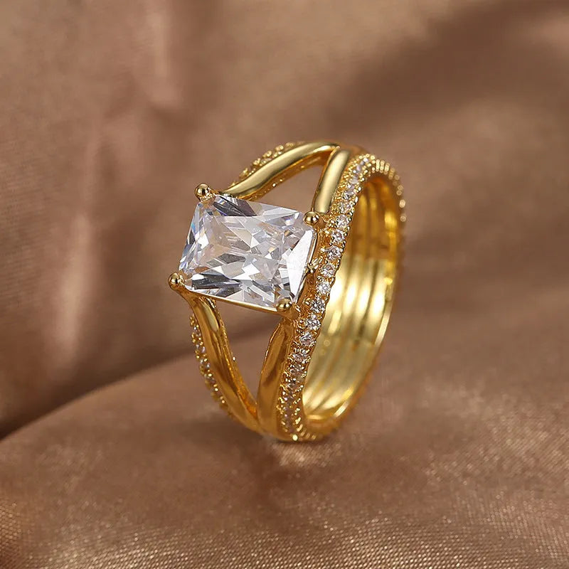 Gold colour geometric women's ring with a square zircon stone on a copper band.