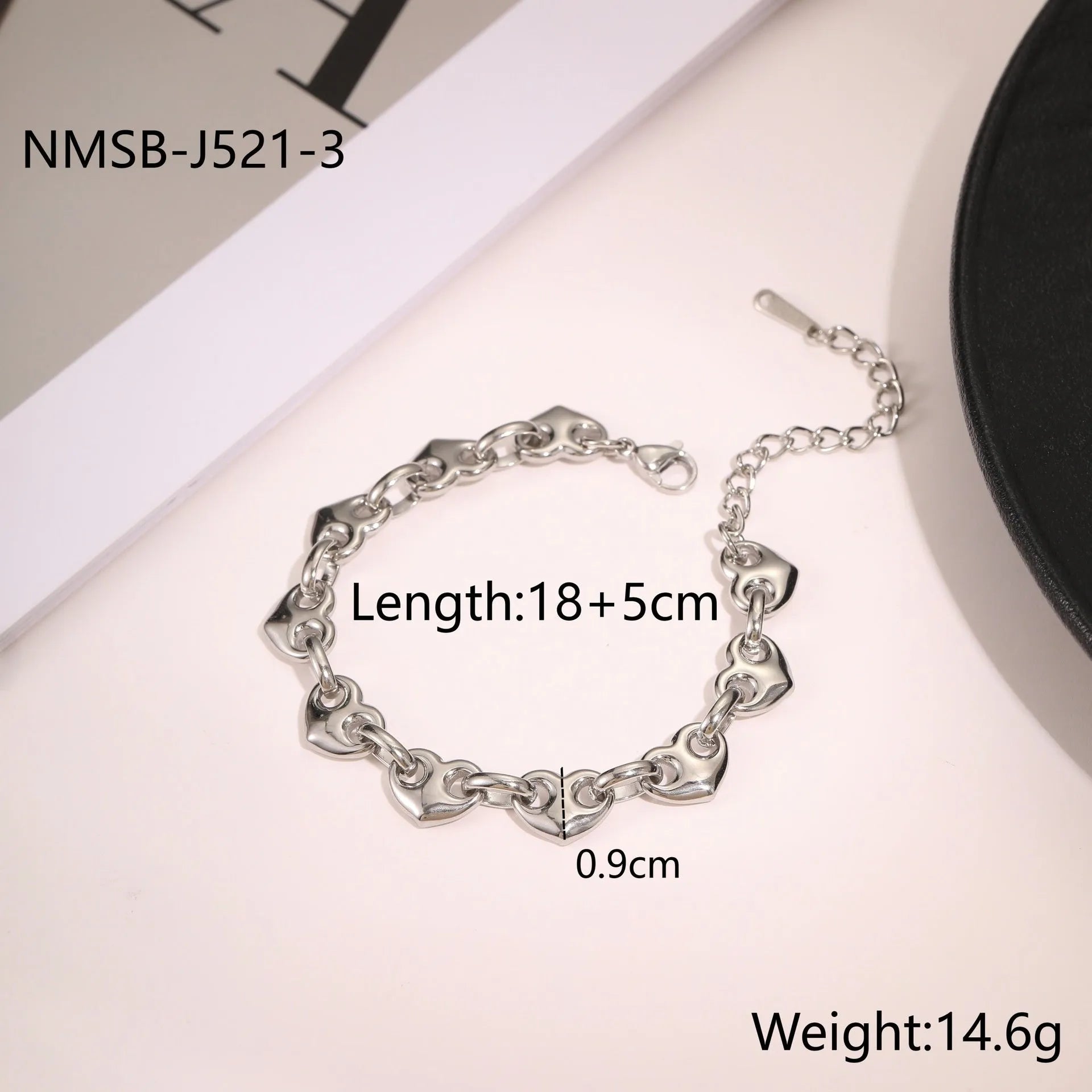 Hollowed-out heart geometry bracelet in stainless steel with gold electroplated finish on a wrist.