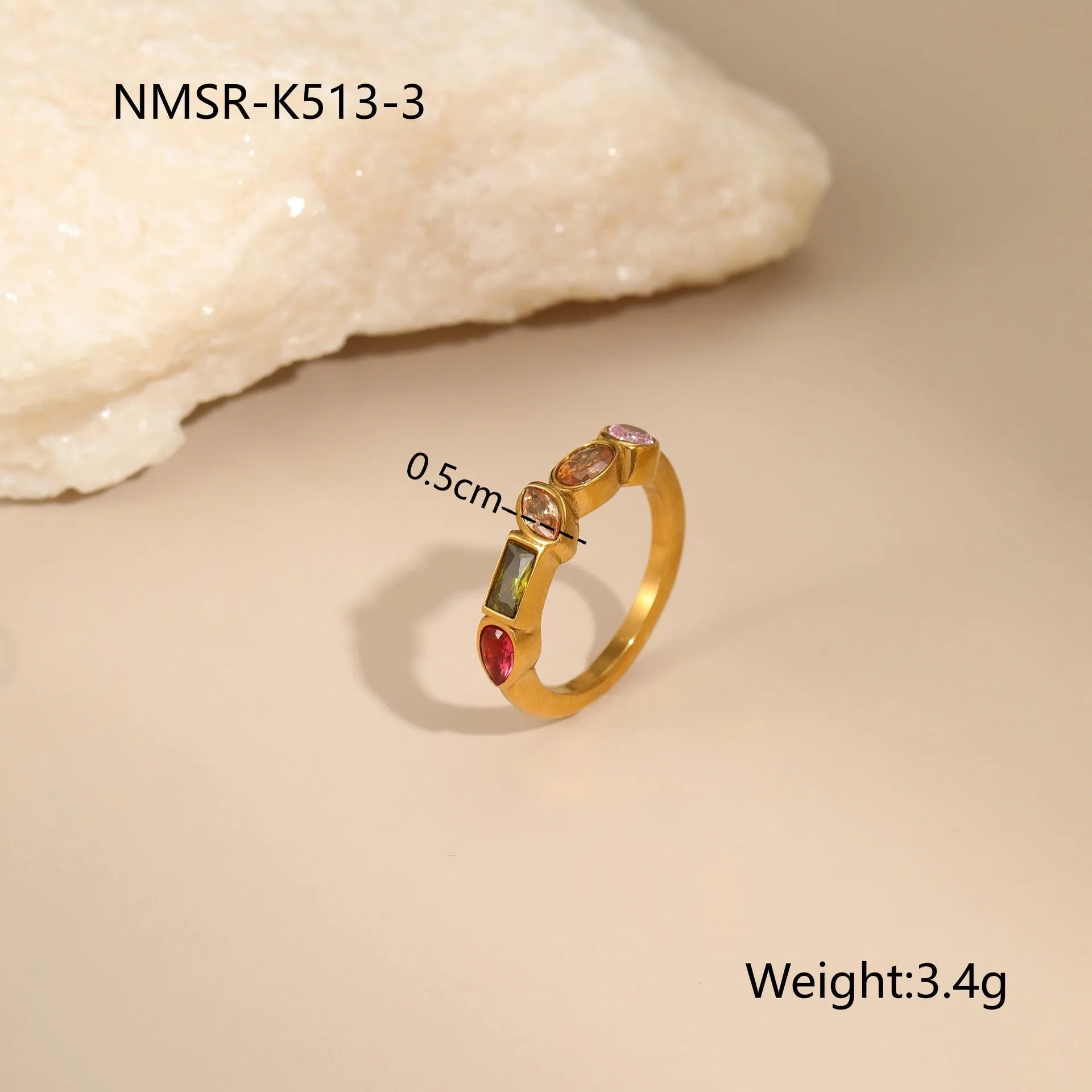 Geometric gold plated zircon jewellery set showing necklace, ring, and earrings on a grey background.