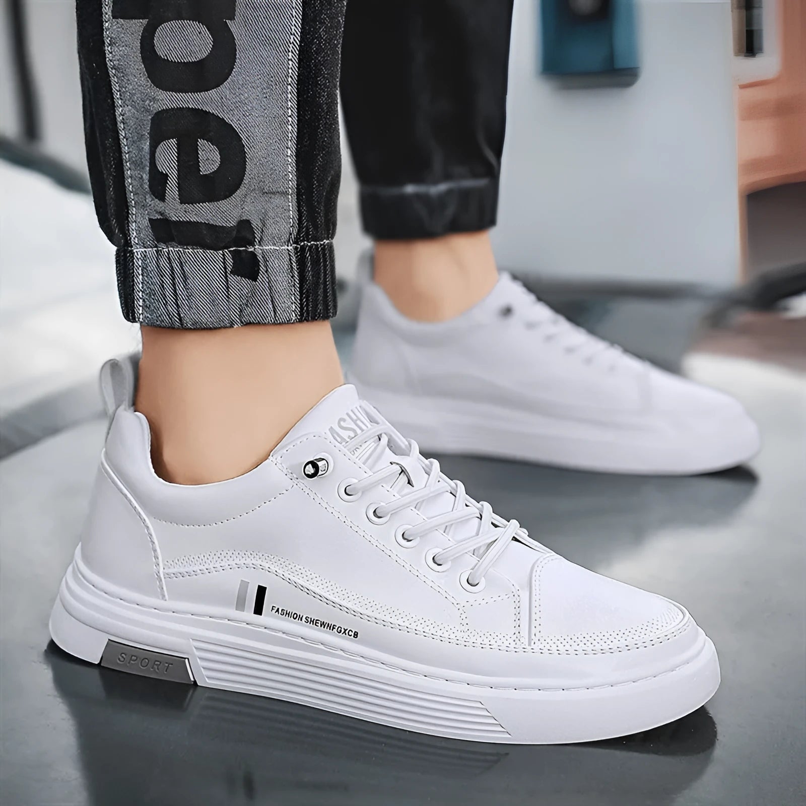 Men's white and black low-top skateboard shoes with elastic band fastening and rubber sole.