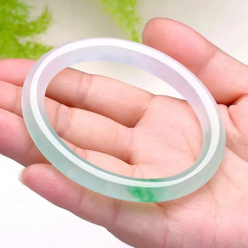 Jade bracelet with floating flower design and auspicious cloud patterns in ice-like emerald finish