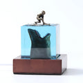 Epoxy resin shark surfer night light ornament with crystal glue details on blue background