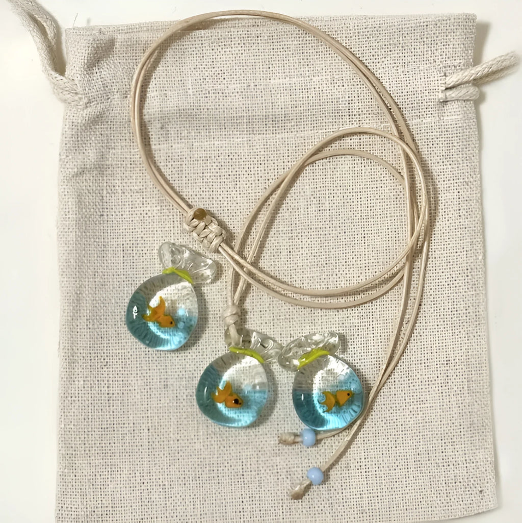 Women's necklace with coloured glaze pendant on a cotton and linen clavicle chain.