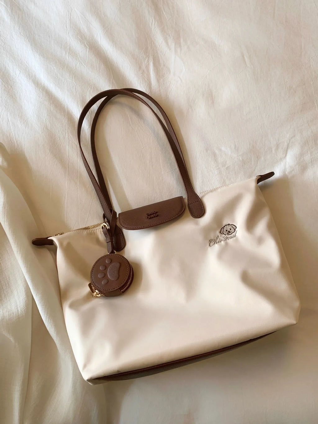 Pink Oxford cloth shoulder tote with sandwich pockets and square shape showing internal mobile phone compartment