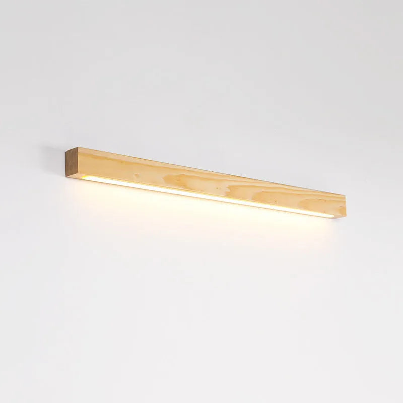 Slim walnut-coloured wooden strip LED wall lamp in three length options on a white wall.