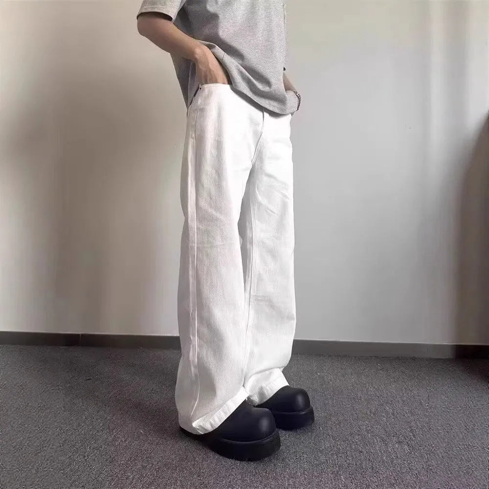 Men's white loose straight-leg cotton denim jeans with wide cut and zipper fly