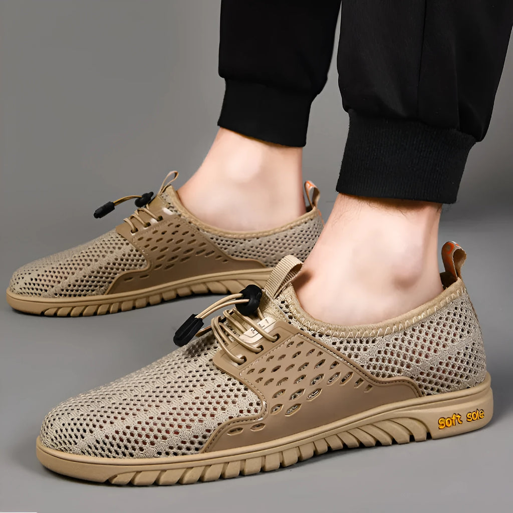 Men's breathable black mesh casual shoe with elastic band closure and rubber sole.