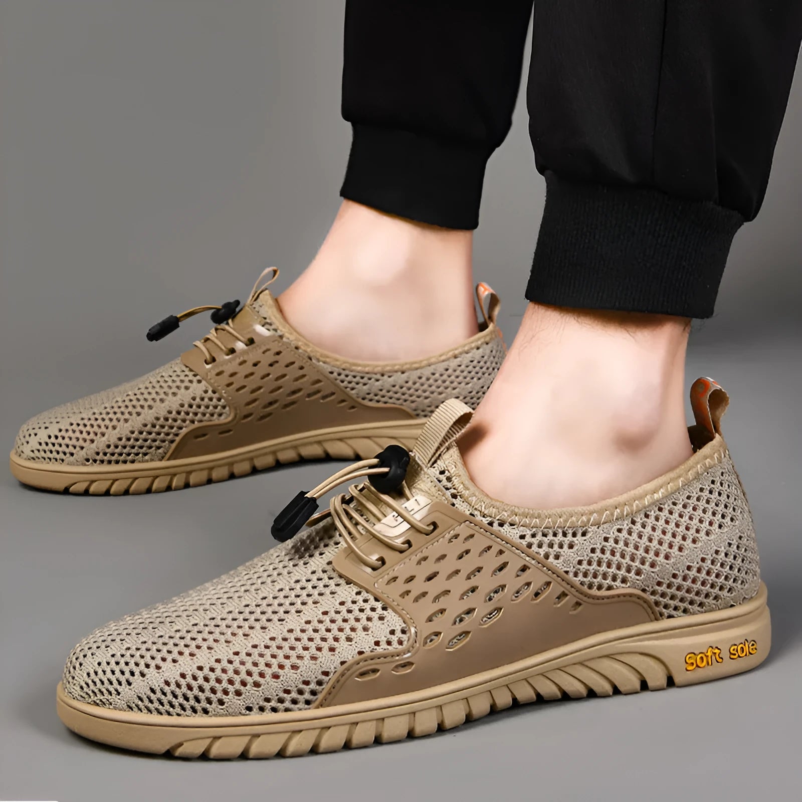 Men's breathable black mesh casual shoe with elastic band closure and rubber sole.