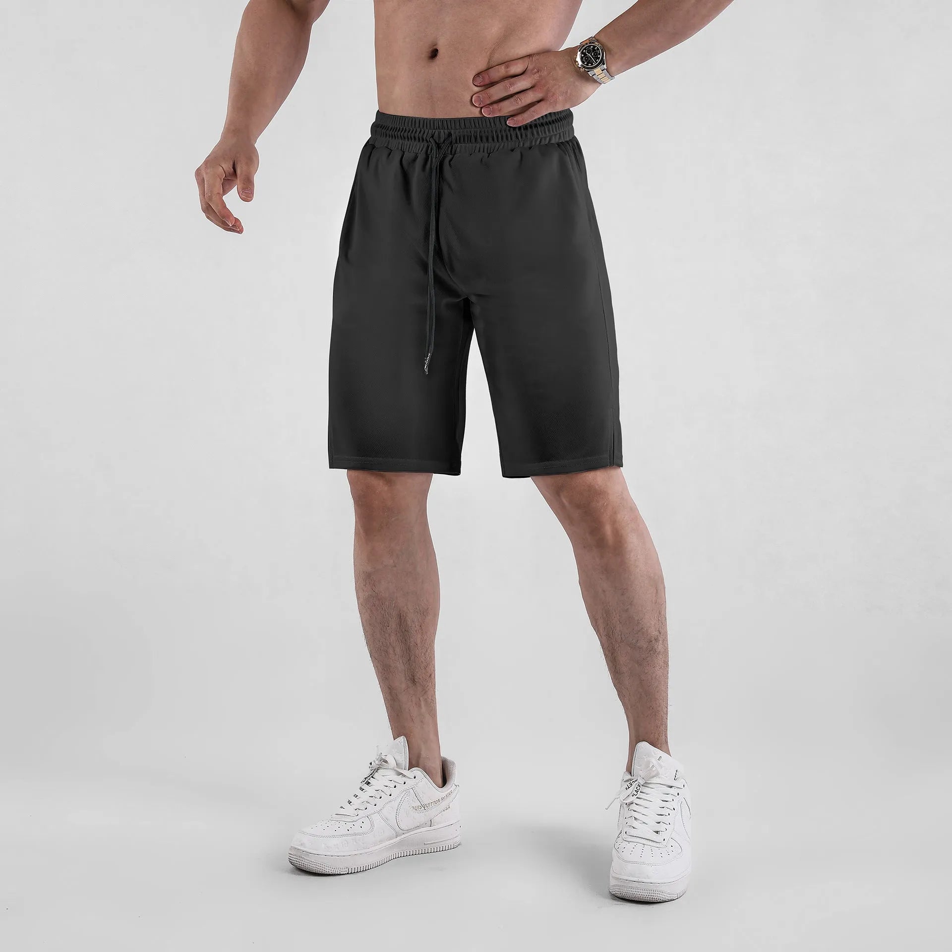 A pair of men's black mesh sports shorts with a loose fit and elasticated waistband.