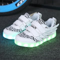 Children's plum red LED light-up sneakers with USB charging port and colourful luminous soles.