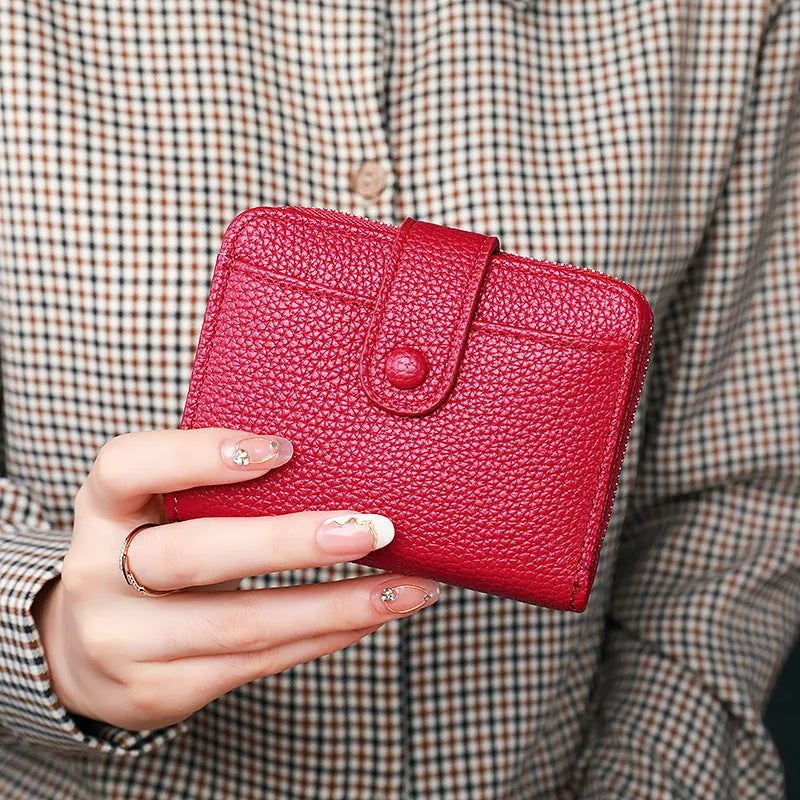 Women's short organ wallet with lychee pattern in pu leather, showing antibacterial lining and reinforced sewing thread detail