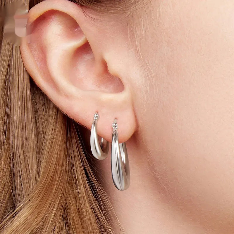 Women's geometric ring clip earrings in silver finish, available in three sizes